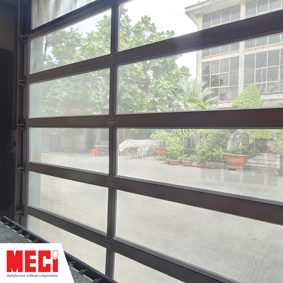 Cửa dạng lưới nhìn từ bên trong thấy được khung cảnh bên ngoài