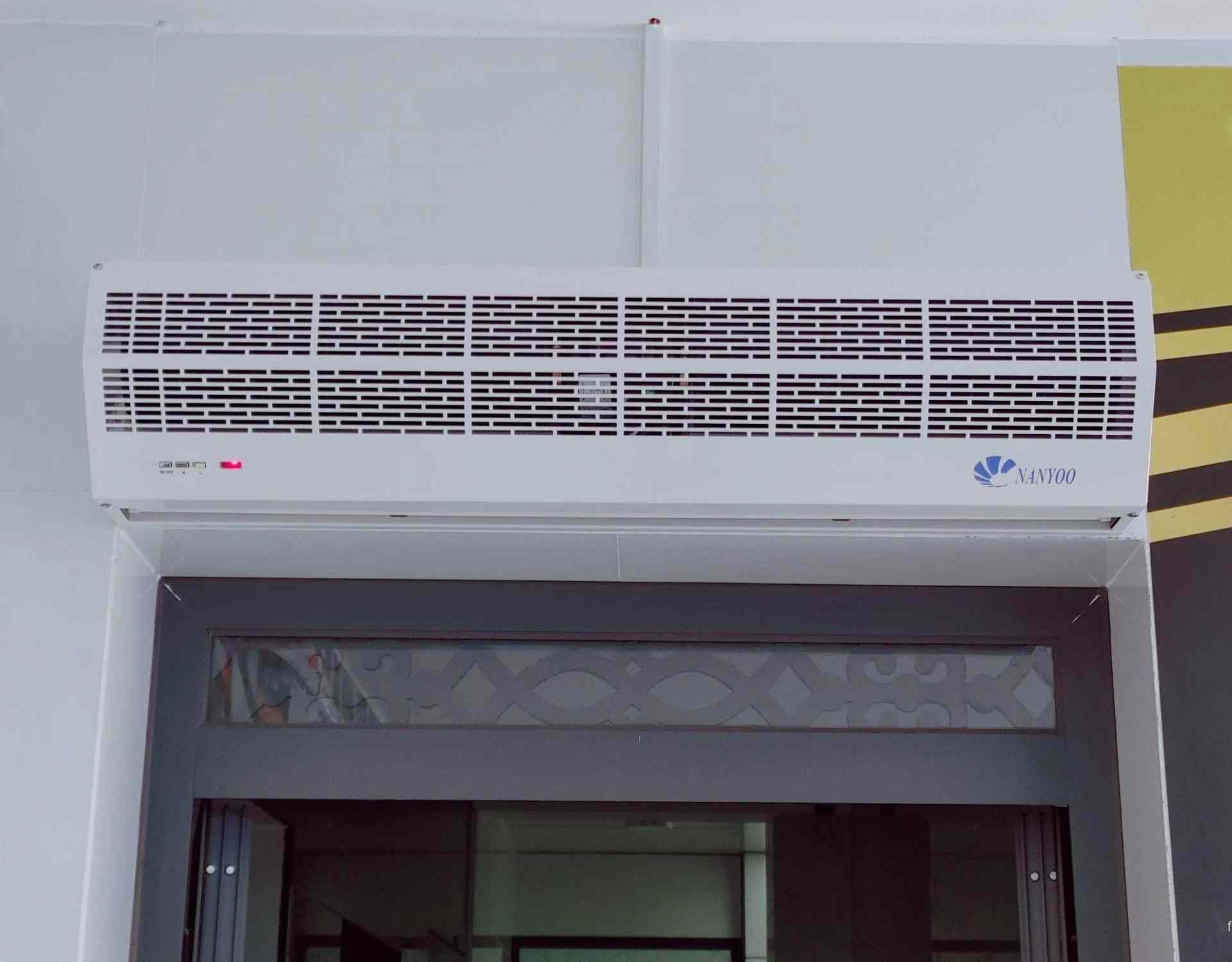 một chiếc quạt cắt gió Nanyoo được lắp cố định vào tường thạch cao phía trên lối vào
