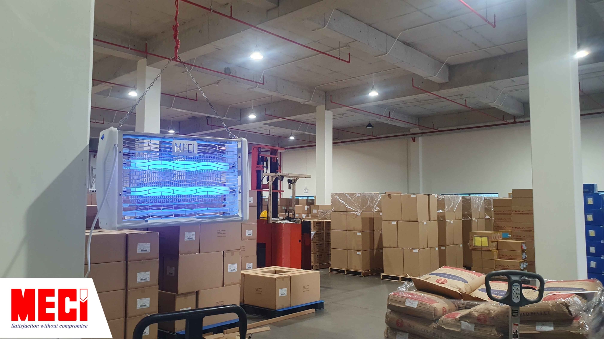 đèn diệt côn trùng đang treo trong kho hàng có nhiều thùng carton
